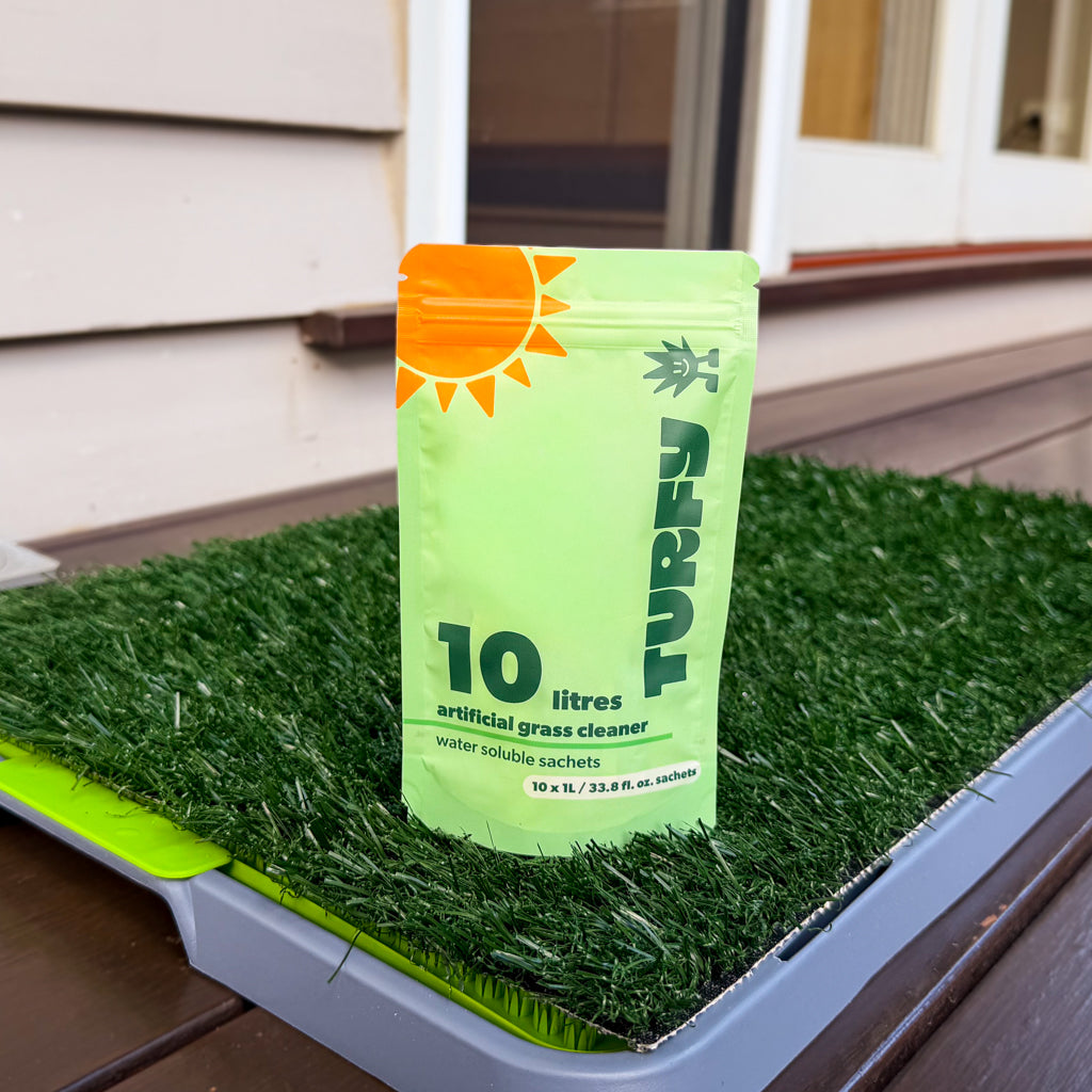 Turfy small 10 litre turf cleaner refill pack on small area of fake grass with 10 dissolvable sachets containing probiotic enzyme and bacteria solution made for small areas to remove dog urine.
